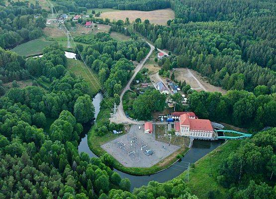 Widok z góry na elektrownię, widać zielone rury doprowadzające wodę i okoliczne drogi